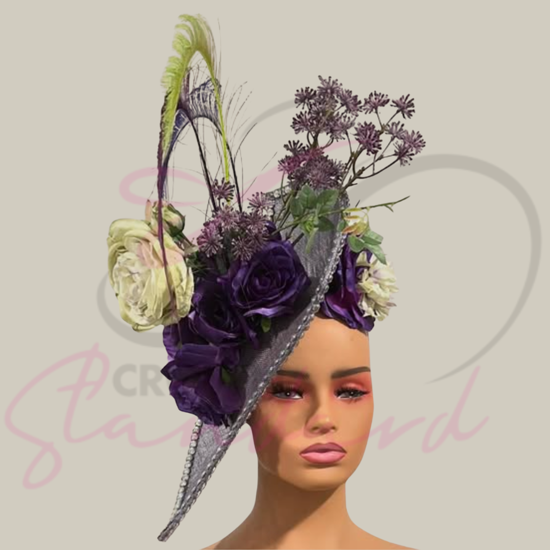 A floral masterpiece: a lavender fascinator showcasing diverse purple and green flowers, with added sparkle and feather details!