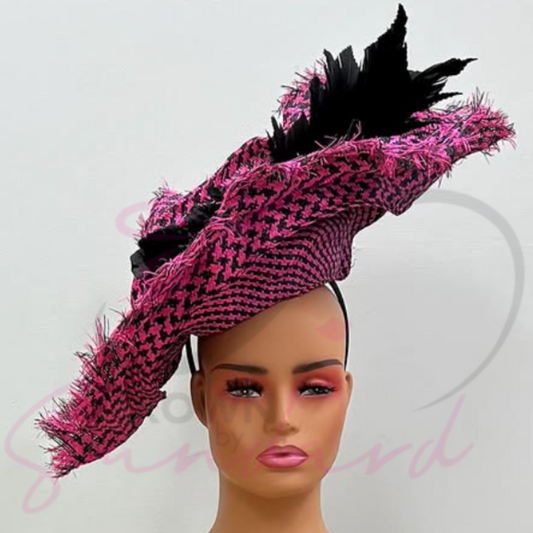 Hot pink and black fascinator with a flower and feather