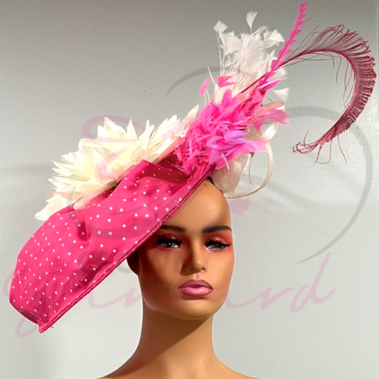This is a gorgeous Pink and white fascinator with a polka dot pattern and pink and white feathers.