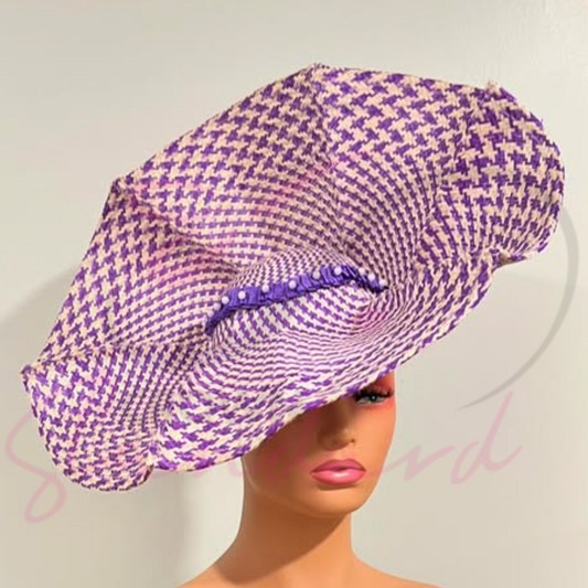 Buntal hat features a striking purple and white checkered design, complemented by a smooth purple satin ribbon adorned with delicate pearl beads.